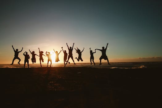 pexels-photo-1000445-1000445 Silhouette of a group of friends jumping on a beach at sunset, expressing joy and freedom.