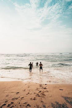 pexels-photo-1056497-1056497 Three friends run into the ocean on a sunny day at a scenic beach in Bali.